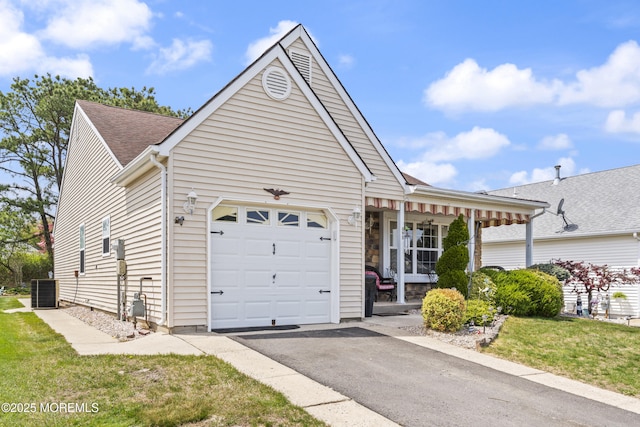 view of front facade featuring cooling unit, driveway, an attached garage, and roof with shingles