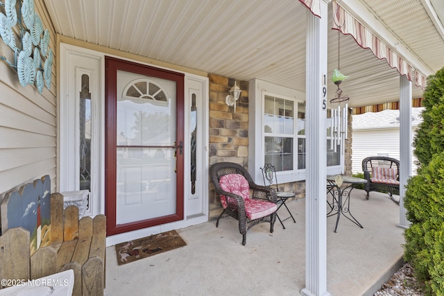 property entrance with stone siding and covered porch