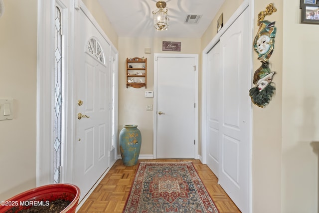 entrance foyer with baseboards and visible vents