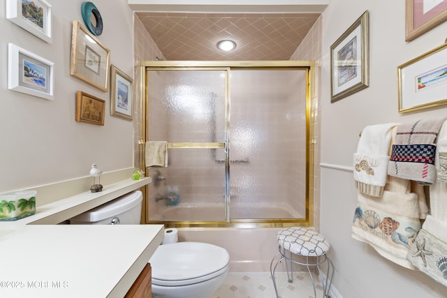 bathroom with toilet, shower / bath combination with glass door, and vanity