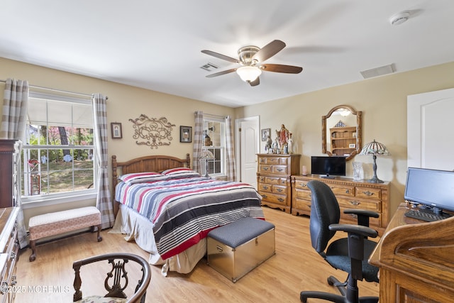 bedroom featuring visible vents, wood finished floors, and ceiling fan