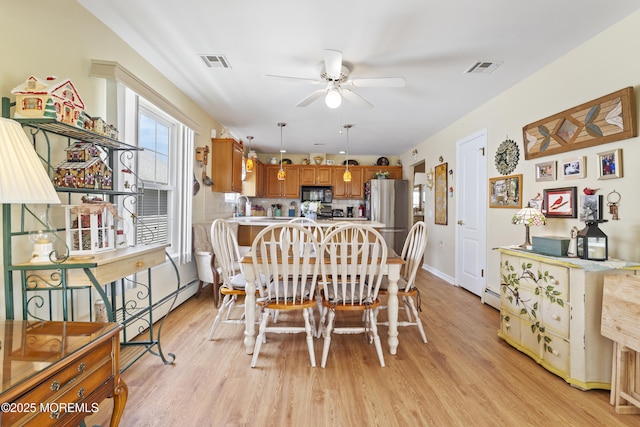 dining room with visible vents, ceiling fan, and light wood-style floors