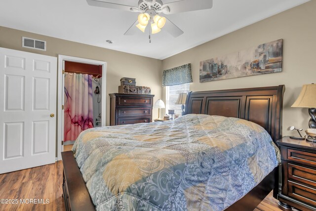 bedroom featuring visible vents, ceiling fan, and wood finished floors