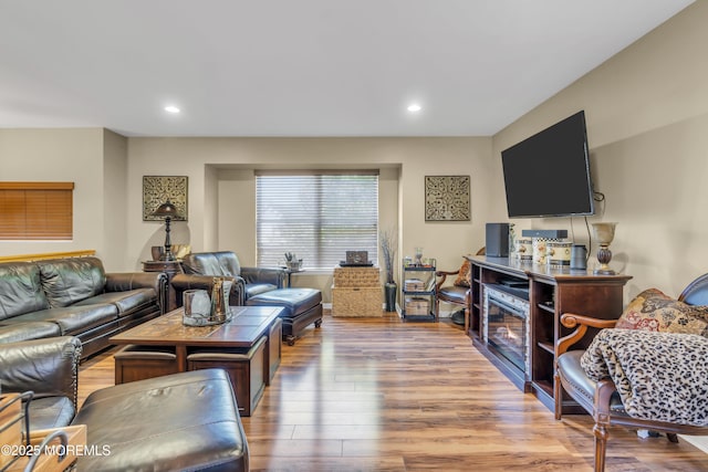 living area with recessed lighting and wood finished floors