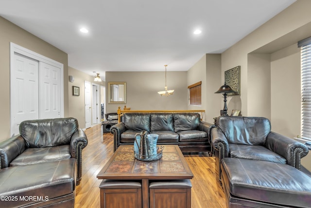 living room with light wood-type flooring and recessed lighting
