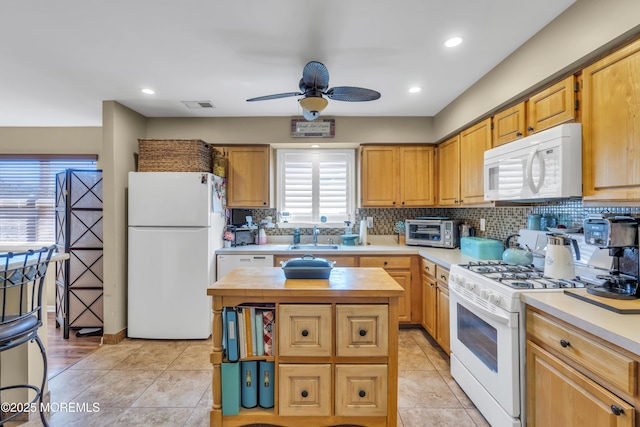 kitchen featuring visible vents, a toaster, white appliances, butcher block countertops, and a ceiling fan
