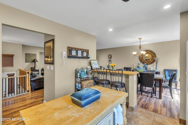 dining space with recessed lighting, light wood finished floors, and a chandelier