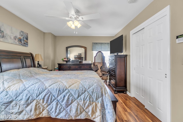 bedroom with a closet, a ceiling fan, and wood finished floors