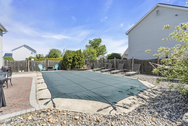 view of swimming pool featuring a patio, a fenced in pool, and a fenced backyard