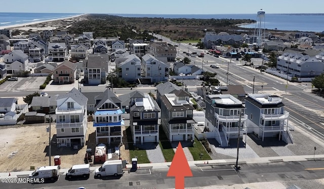 drone / aerial view featuring a water view and a residential view