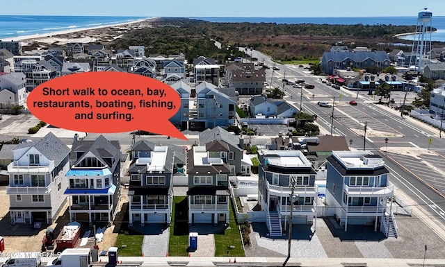 birds eye view of property with a water view and a residential view