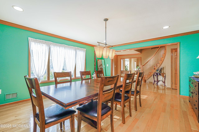 dining area featuring visible vents, ornamental molding, stairs, and plenty of natural light