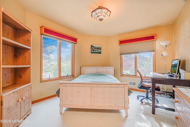 carpeted bedroom with baseboards and visible vents