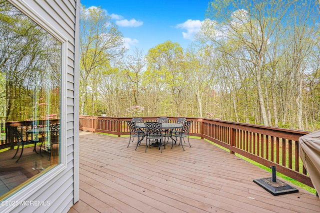 wooden deck featuring outdoor dining area