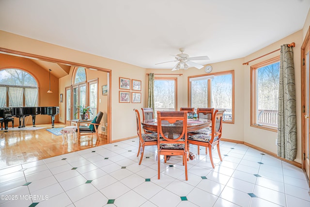 dining area featuring a healthy amount of sunlight, baseboards, and ceiling fan