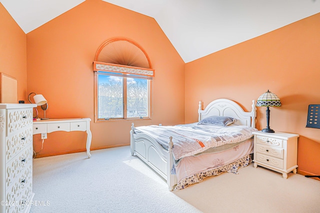 bedroom with carpet flooring, baseboards, and lofted ceiling