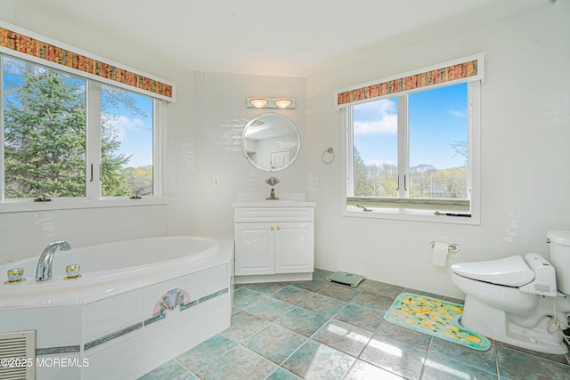 full bathroom featuring vanity, plenty of natural light, a garden tub, and toilet