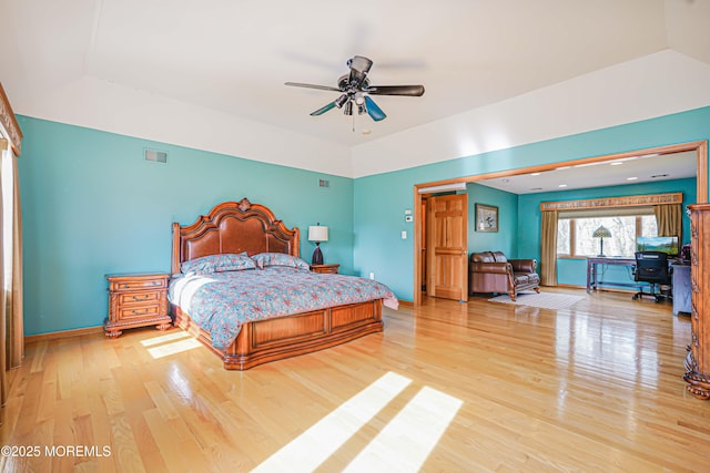 bedroom with baseboards, visible vents, and light wood-style flooring