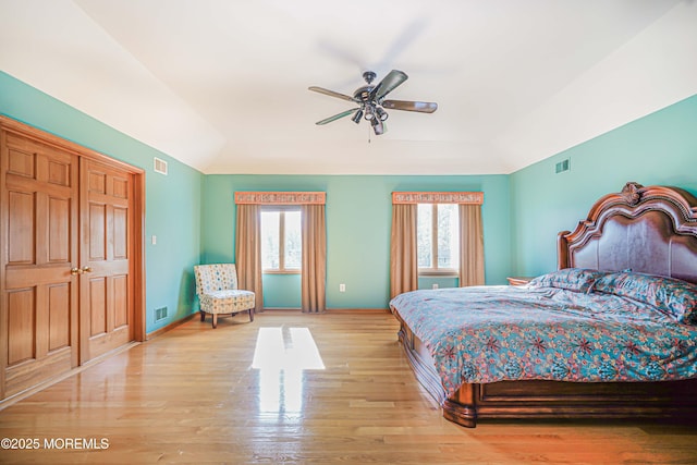 bedroom featuring light wood-style floors, multiple windows, and visible vents