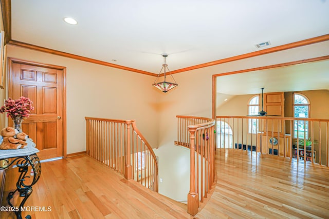 hall featuring recessed lighting, baseboards, an upstairs landing, wood finished floors, and visible vents