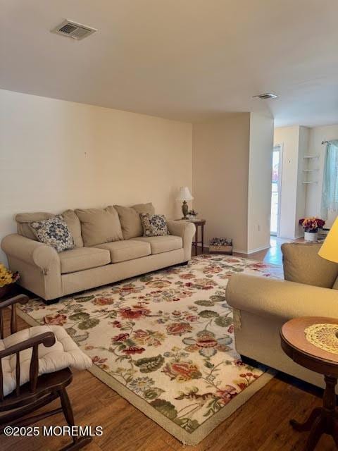 living room with visible vents and wood finished floors