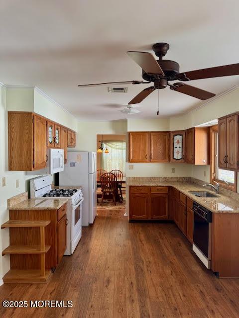 kitchen featuring white appliances, open shelves, brown cabinets, a sink, and visible vents