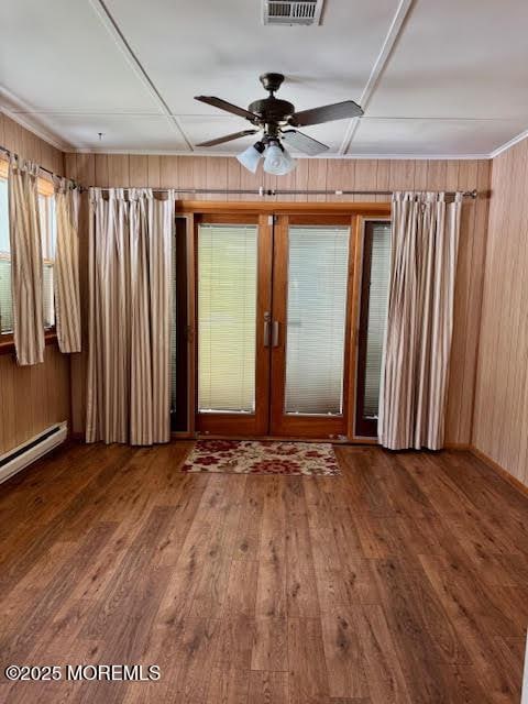spare room featuring wooden walls and wood finished floors
