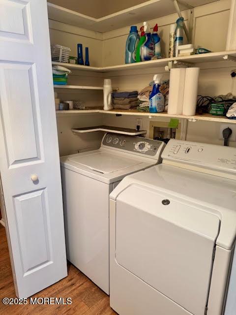 laundry room featuring laundry area, light wood-style flooring, and washing machine and dryer