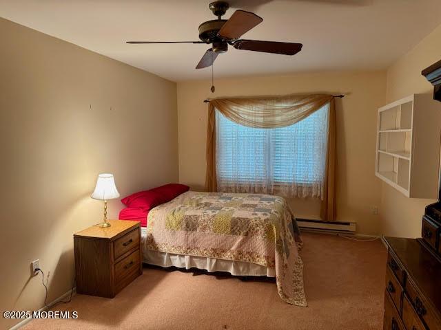 bedroom with a ceiling fan, a baseboard heating unit, and light carpet