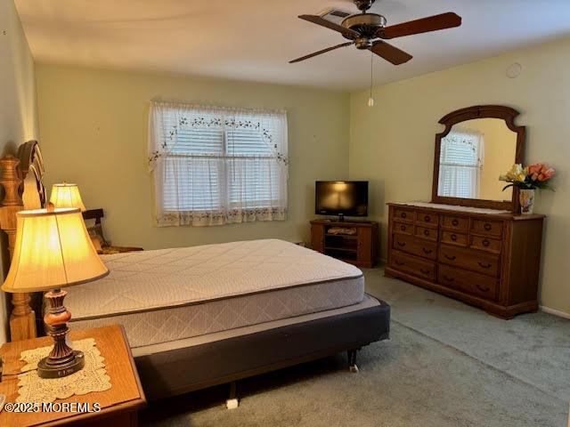 bedroom with ceiling fan and carpet
