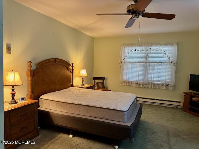 bedroom featuring baseboard heating, ceiling fan, and carpet floors