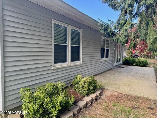 view of side of property with a patio area