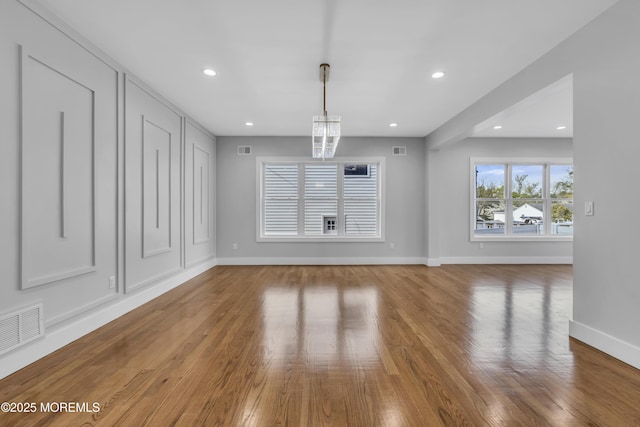 interior space with recessed lighting, visible vents, wood finished floors, and baseboards