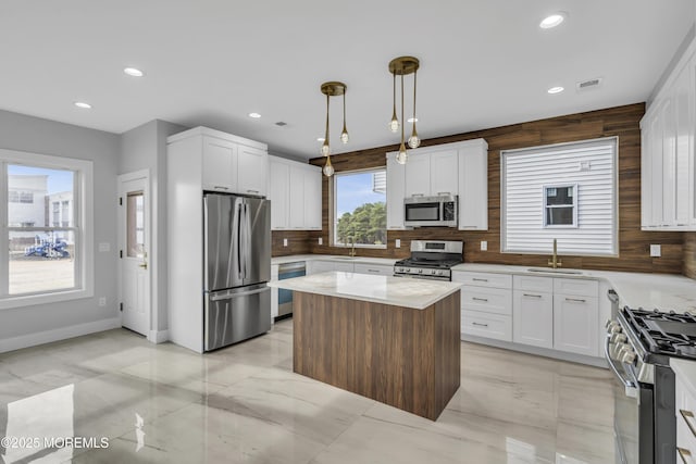 kitchen featuring appliances with stainless steel finishes, backsplash, recessed lighting, and a sink