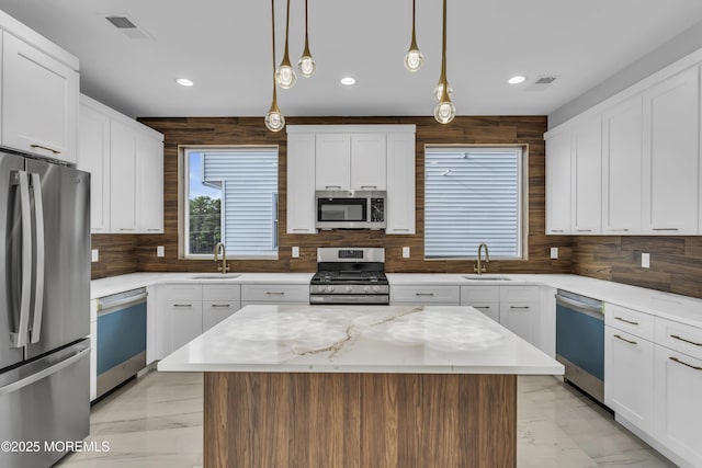 kitchen featuring marble finish floor, a sink, appliances with stainless steel finishes, and visible vents