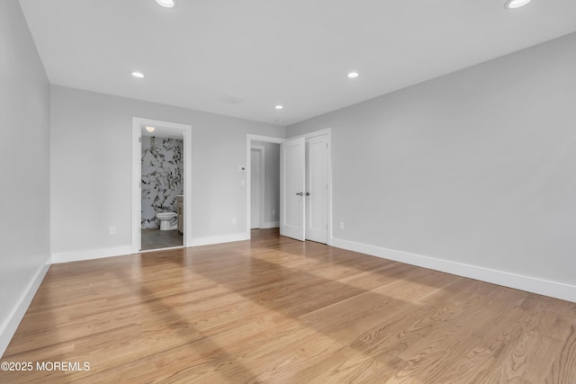interior space featuring recessed lighting, light wood-style flooring, and baseboards