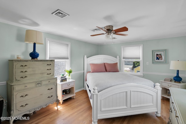 bedroom featuring multiple windows, light wood finished floors, and visible vents