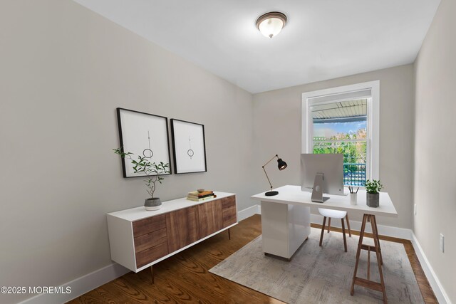 home office featuring baseboards and dark wood-style floors
