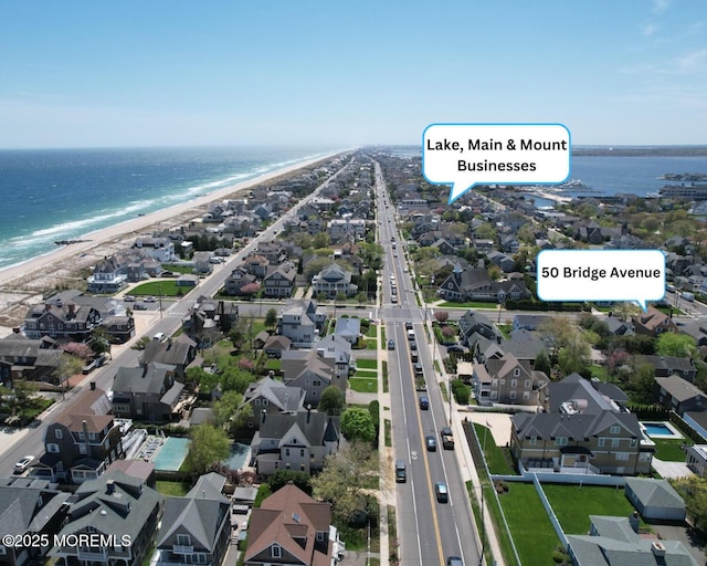 aerial view featuring a water view, a residential view, and a view of the beach