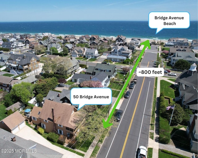 drone / aerial view featuring a water view and a residential view