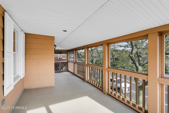 unfurnished sunroom featuring lofted ceiling