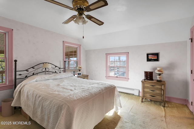 carpeted bedroom with a ceiling fan, lofted ceiling, a baseboard heating unit, and multiple windows