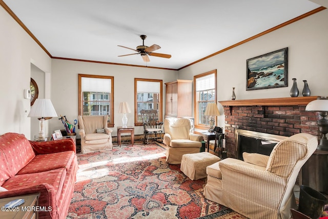living area featuring ornamental molding, ceiling fan, and a fireplace