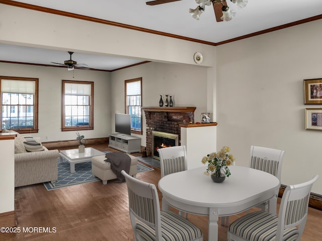 50 Bridge Ave, Bay Head, NJ 08742 - dining area featuring a ceiling fan, wood finished floors, a fireplace, and crown molding