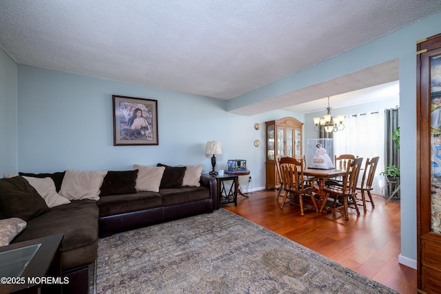 102 Buckingham Dr, Jackson, NJ 08527 - living room with wood finished floors, a chandelier, and a textured ceiling