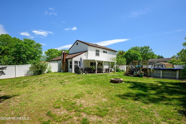 102 Buckingham Dr, Jackson, NJ 08527 - rear view of house with a fire pit
