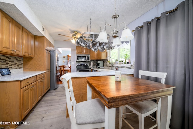 102 Buckingham Dr, Jackson, NJ 08527 - dining area featuring a chandelier, light wood-type flooring, ceiling fan, and a textured ceiling