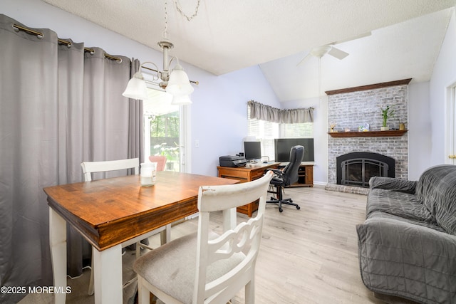 102 Buckingham Dr, Jackson, NJ 08527 - dining area with light wood-type flooring, ceiling fan, lofted ceiling, a brick fireplace, and a desk