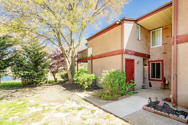 view of side of home featuring brick siding