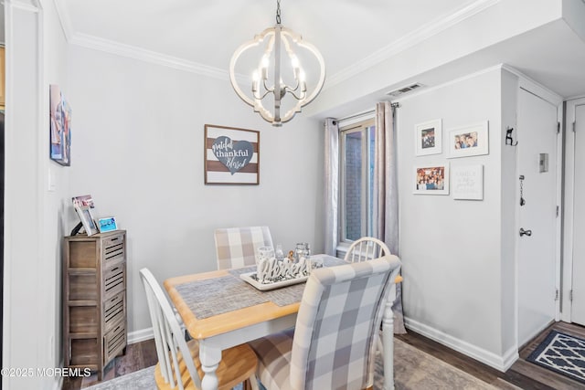 dining room featuring baseboards, a chandelier, wood finished floors, and visible vents